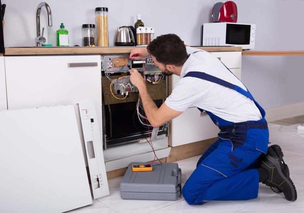 workman-fixing-a-dishwasher-scaled.jpg